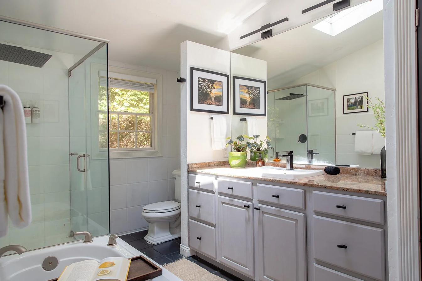 Primary bathroom with skylight and dual vanity
